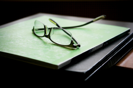 glasses on green folder